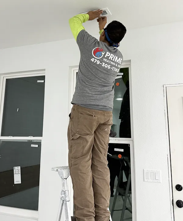 A technician installs ducts and vents for an AC Installation